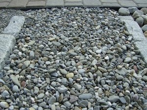 Sand and gravel next to a patio