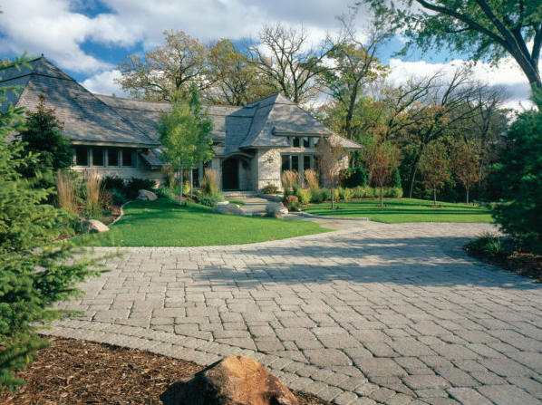 Pavestone pavers driveway leading to a large home