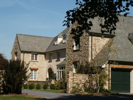 Light brown stone home with gray roof