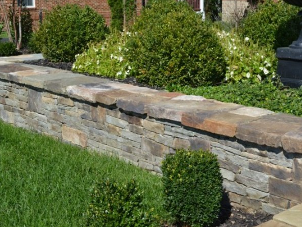 Outdoor low decorative stone wall with greenery