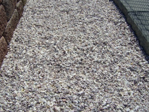 Crushed stone next to concrete slabs