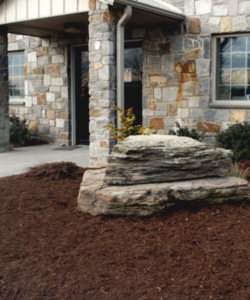 Stacked boulders on mulch