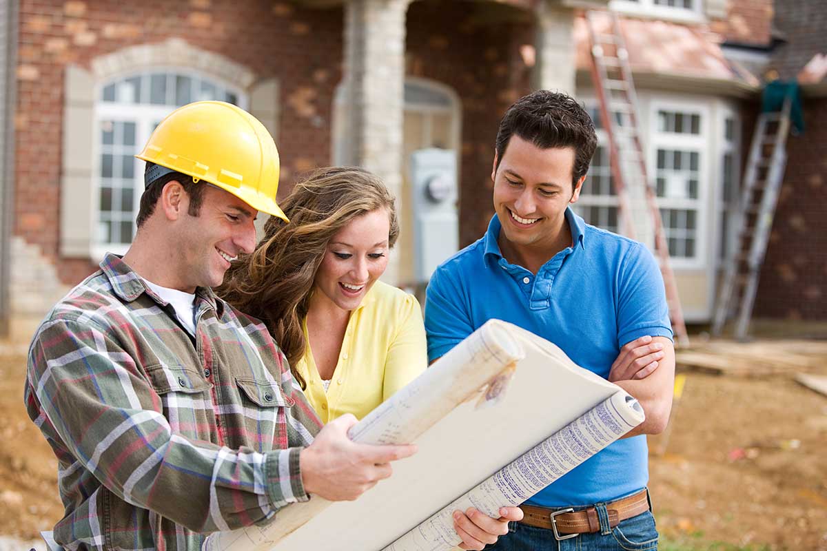 Contractor reviewing plans with a couple