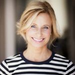 Mature woman in striped shirt smiling